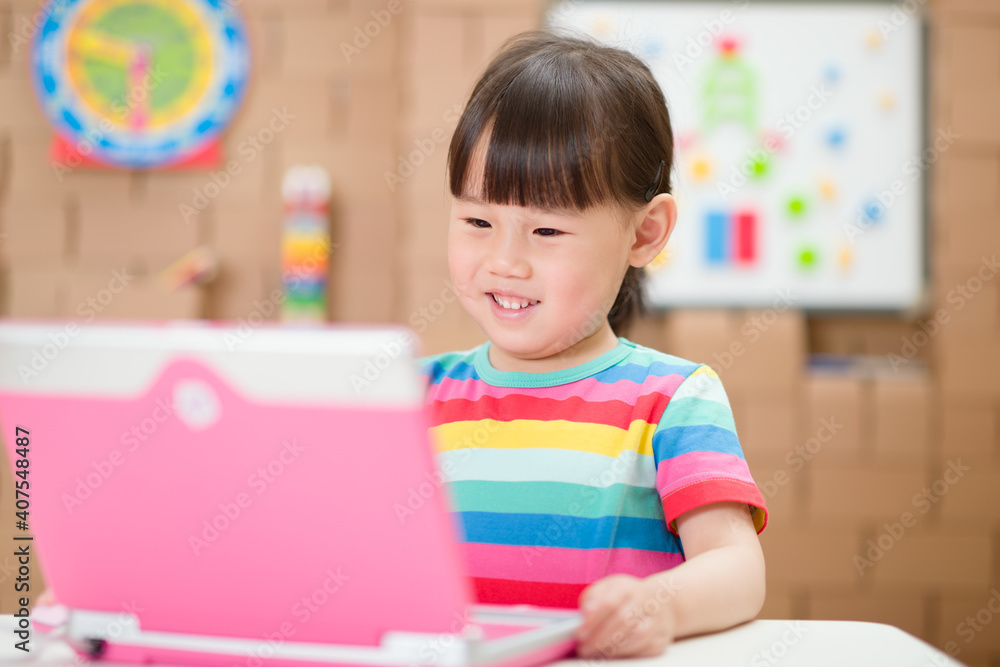 young girl using laptop for online learning during lockdown time young girl using laptop for online learning during lockdown time