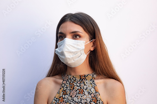 Obraz na plátně Young and beautiful woman in white mask