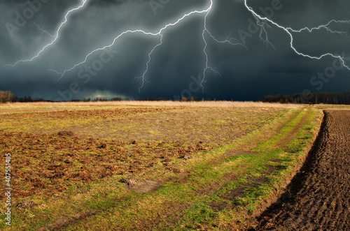 lightning over the meadow. stormy sky over rural landscape
