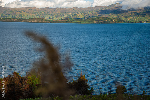 tardeando cerca a la laguna, un pueblo y los cultivos  photo