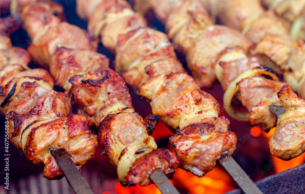 Shish kebab of meat skewered on a grill