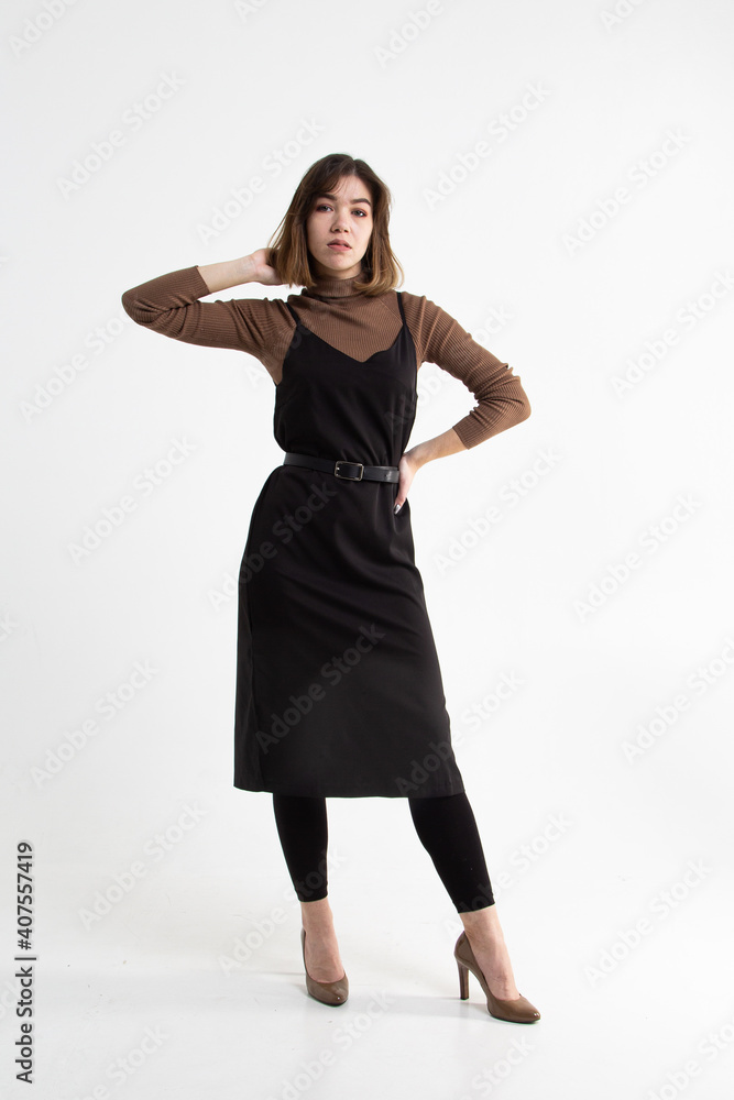 Full length portrait of brunette girl in black and brown clothes on high heels isolated on white studio background. Vertical view
Full length portrait of brunette girl in black and brown clothes on high heels isolated on white studio background. Vertical view