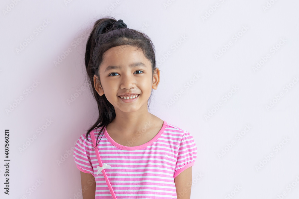 The child tied up black hair and smiled with happiness. The child tied up black hair and smiled with happiness.