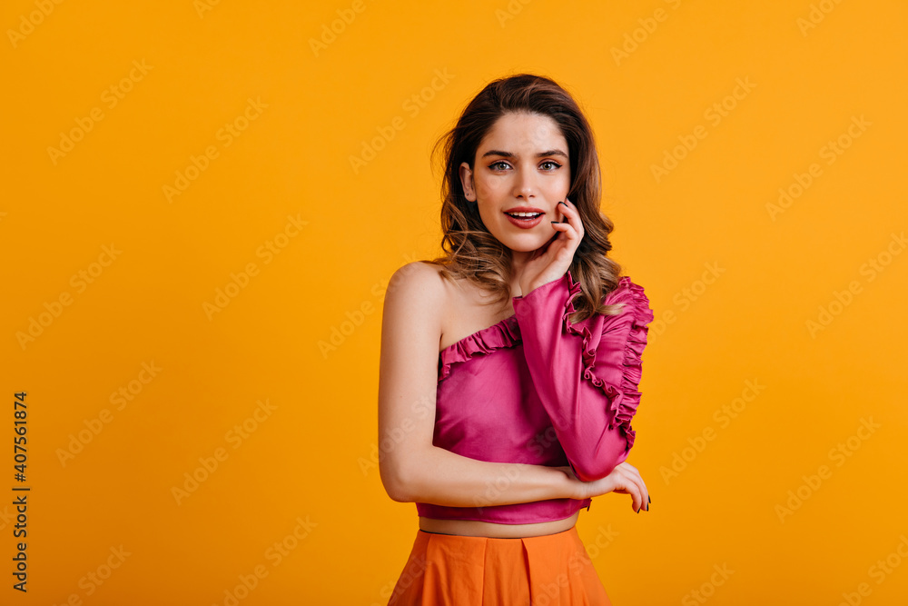 Gorgeous girl posing with pretty smile. Well-dressed inspired model standing on yellow background. Gorgeous girl posing with pretty smile. Well-dressed inspired model standing on yellow background.