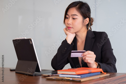 Busiesswoman holding creditcard and using laptop computer for online shopping, Online Payment, e-commerce, internet banking. photo