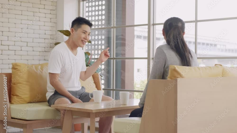 Happy Asian beautiful lifestyle family couple husband and wife laughing sitting in a cafe drinking coffee having talking conversation together inmorning. Two people in cafe enjoying. Slow motion Happy Asian beautiful lifestyle family couple husband and wife laughing sitting in a cafe drinking coffee having talking conversation together inmorning. Two people in cafe enjoying. Slow motion
