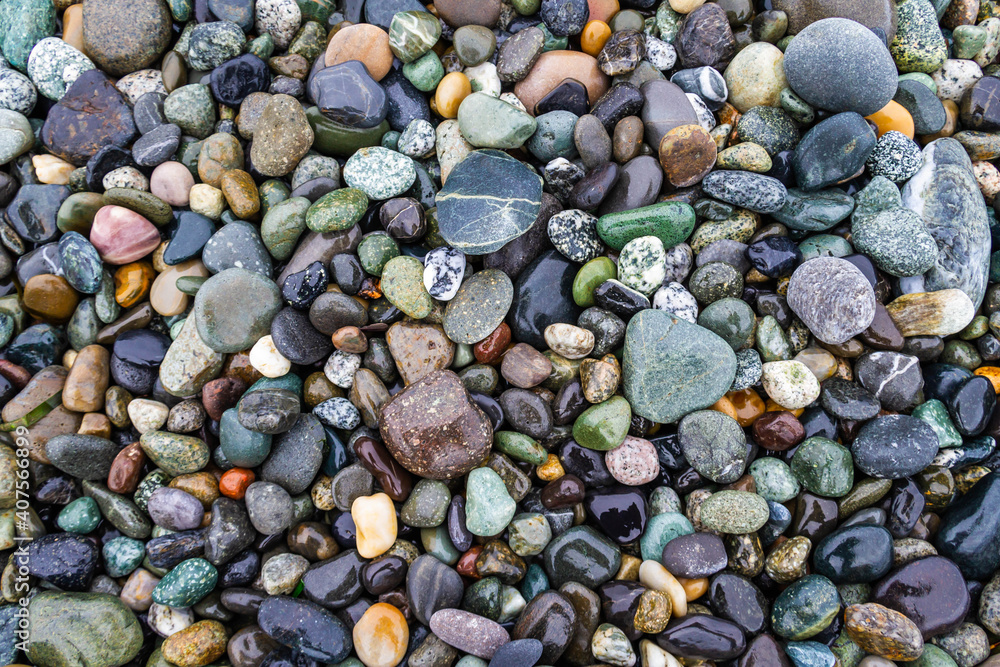 Colorful smooth rocks on the beach covered in water. Colorful smooth rocks on the beach covered in water.