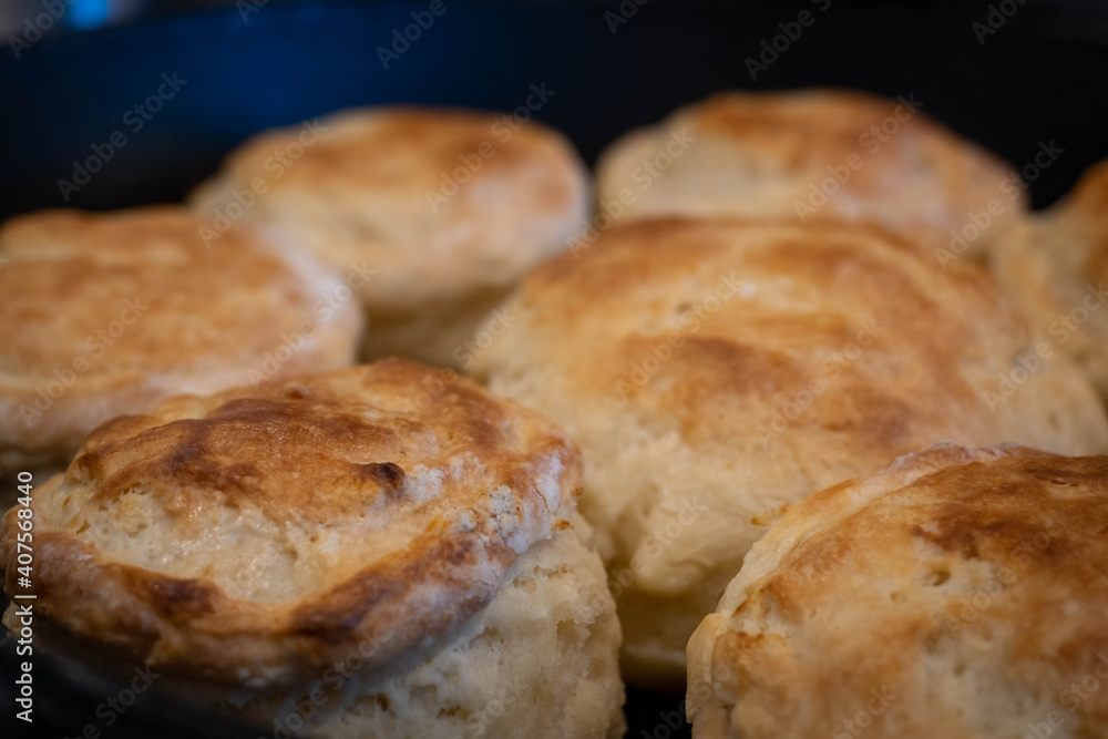 Freshly baked golden brown biscuits, front left in focus