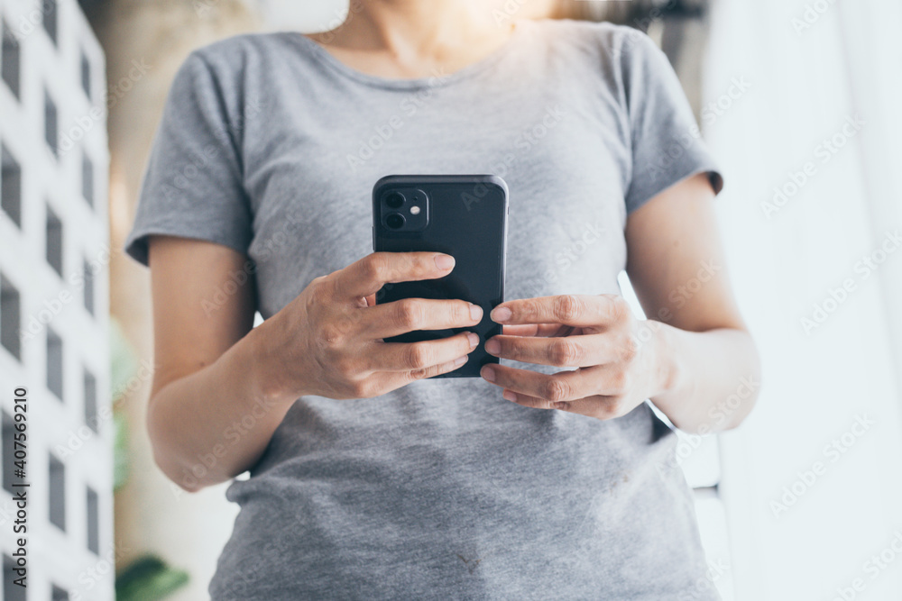 using cell phone hand holding mobile texting message contact us.chatting,search internet information in office.technology device communication connecting using cell phone hand holding mobile texting message contact us.chatting,search internet information in office.technology device communication connecting