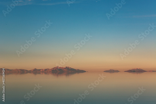 Mountain mirages with big sky in Bolivian salt flats