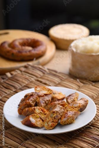 Northern Thai sausage (Sai Aua), Grilled intestine stuffed with minced pork, spices and herbs eating with sticky rice, popular food in Chiangmai, Thailand