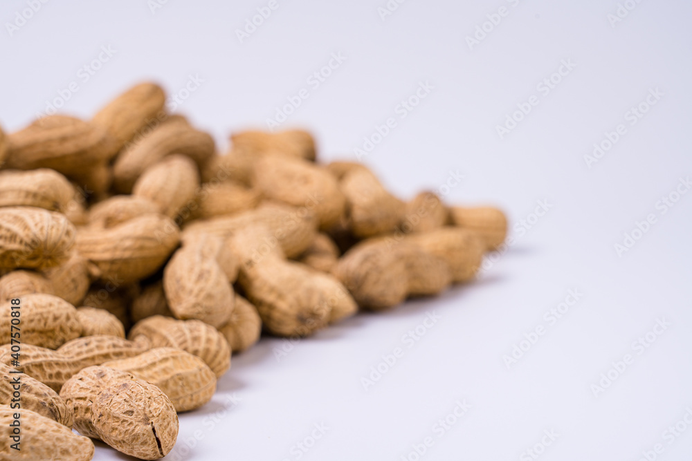Peanuts with shells on white background Peanuts with shells on white background