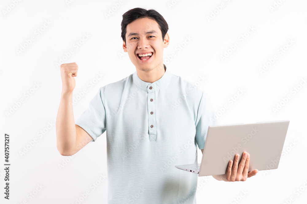 Emotional young man with laptop celebrating victory over white background Emotional young man with laptop celebrating victory over white background