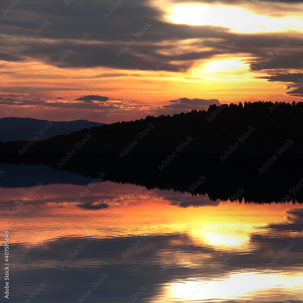 Beautiful reflection of a bright sunset in the lake