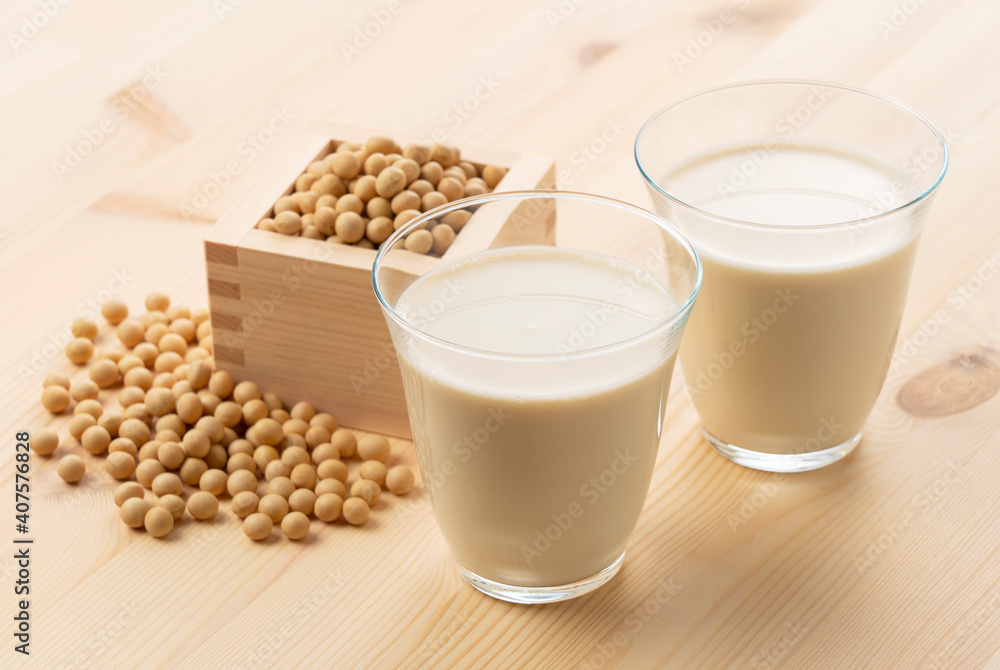 Soy milk in a glass on a wooden background Soy milk in a glass on a wooden background