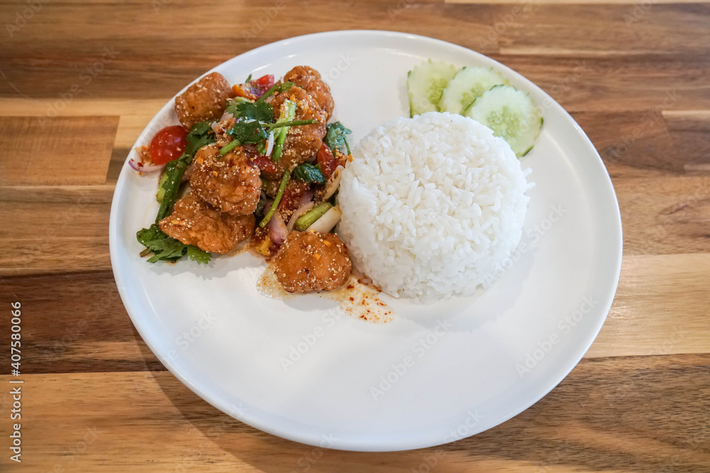 Jasmine rice with spicy chicken deep fried on white plate for quick lunch Jasmine rice with spicy chicken deep fried on white plate for quick lunch
