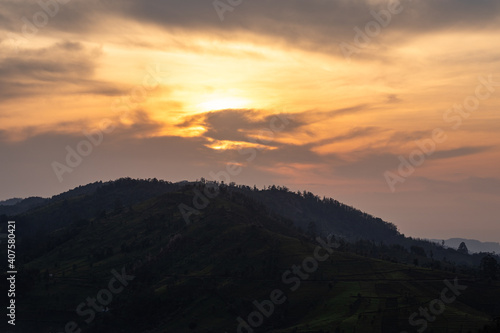 mountain dawn view with orange sky and tea garden