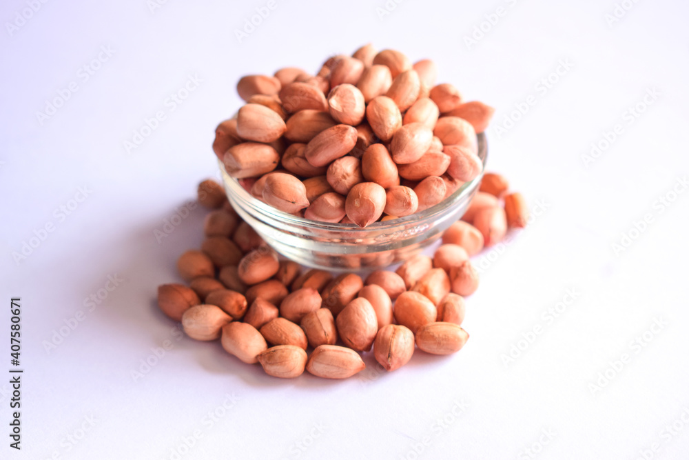 Top View of Closeup Peanuts-Groundnut in a Transparent Glass Bowl On isolated White Background Top View of Closeup Peanuts-Groundnut in a Transparent Glass Bowl On isolated White Background