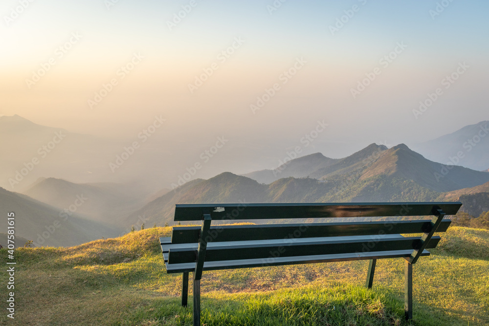isolated sitting bench with pristine natural view of mountains at morning isolated sitting bench with pristine natural view of mountains at morning