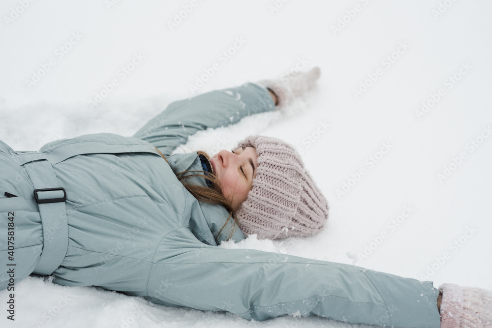 Woman are lying in the snow in winter Woman are lying in the snow in winter