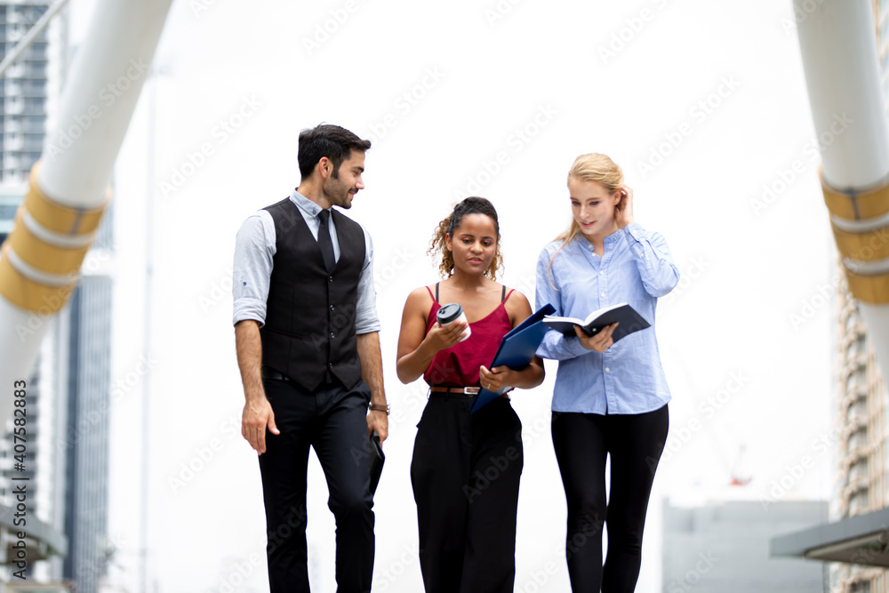 Three business people descending a stairway and talking Three business people descending a stairway and talking