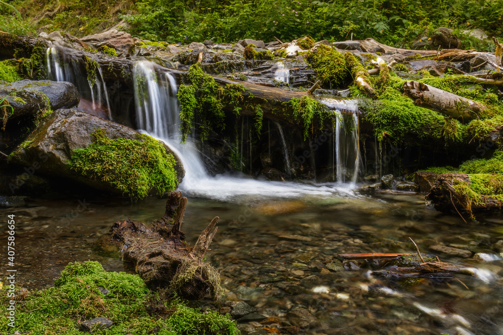 waterfall in the forest mountains