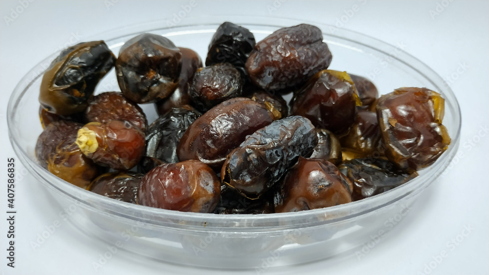 Close up of fresh dates. Dates are a staple food in the Middle East and North Africa, usually eaten during Ramadan for Muslims Close up of fresh dates. Dates are a staple food in the Middle East and North Africa, usually eaten during Ramadan for Muslims