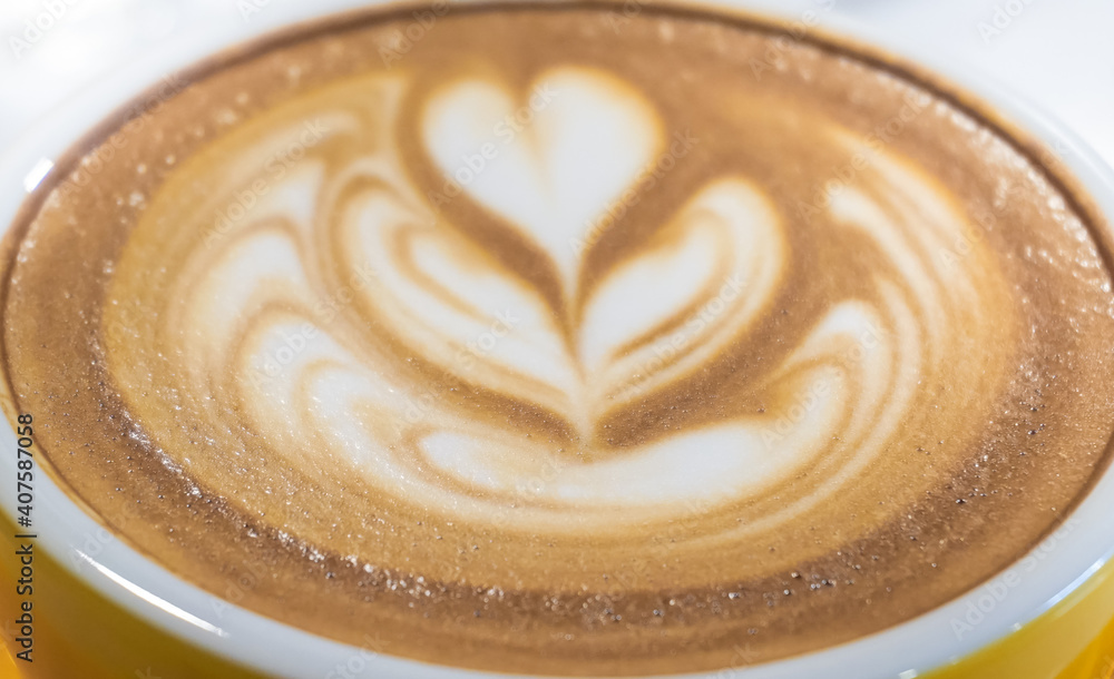 Latte art and yellow cup Latte art and yellow cup