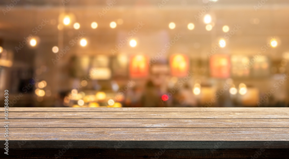Wooden table with blur bokeh cafe restaurant backgrounds, for display products.