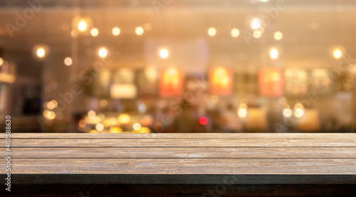 Wooden table with blur bokeh cafe restaurant backgrounds, for display products.