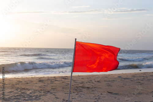 Red flags to warn tourists not to play in the sea because the windy waves can be dangerous.