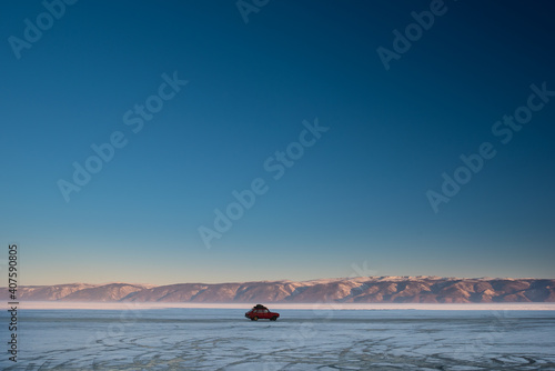 the car rides on the ice of the frozen lake Baikal in winter