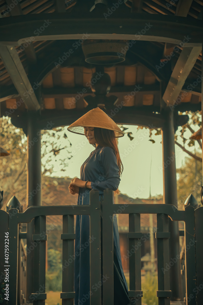 Beautiful Vietnam girl from Hue city, Vietnam who wearing Ao dai. Ao dai is famous traditional custume for woman in Vietnam. Vintage style,travel and relaxing concept. Beautiful Vietnam girl from Hue city, Vietnam who wearing Ao dai. Ao dai is famous traditional custume for woman in Vietnam. Vintage style,travel and relaxing concept.