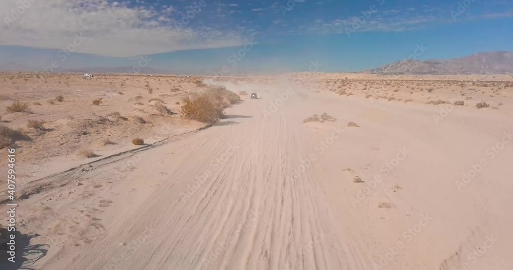 Off-road UTV driving on a dusty desert road Off-road UTV driving on a dusty desert road