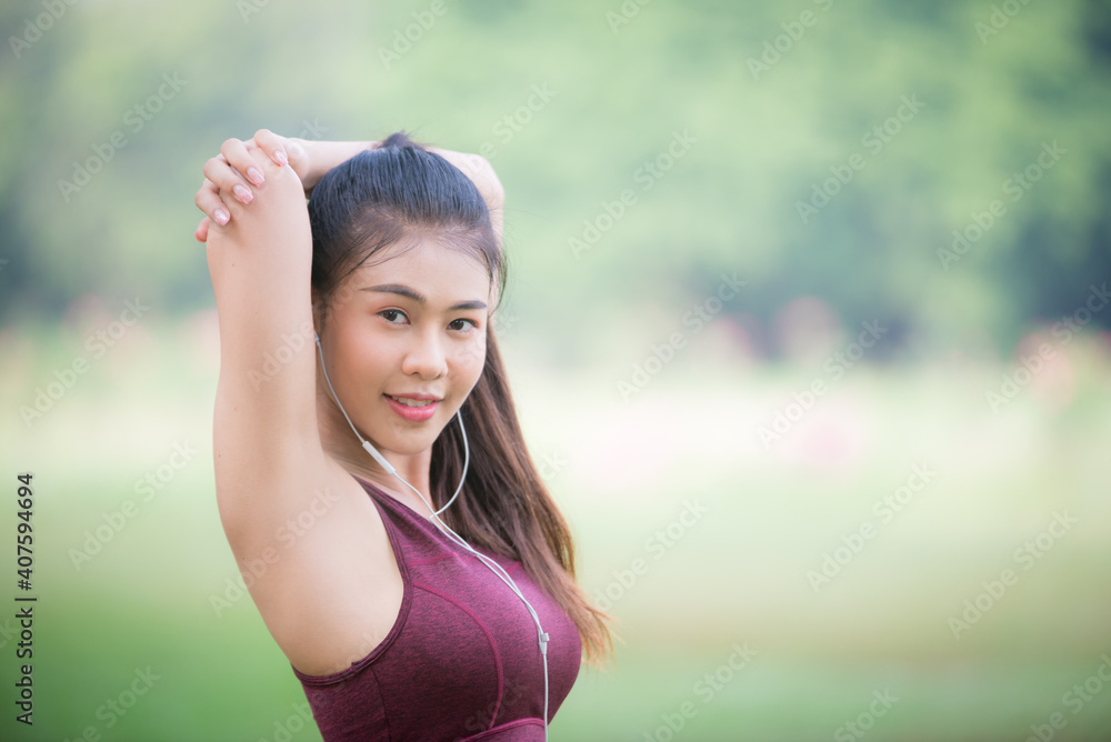 Asian woman is warm up, To make the muscles flexible Before going to jogging for good health and energy
metabolism,Outdoors cross training workout. Healthcare concept