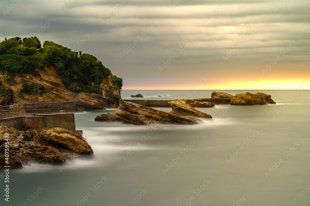 Seascape in Biarritz France in long photographic exposure. Dramatic sky.
