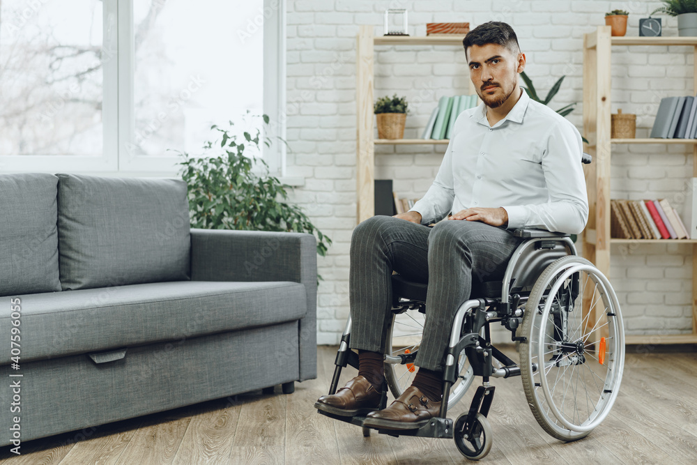 Portrait of disabled man in formal wear sitting in a wheelchair Portrait of disabled man in formal wear sitting in a wheelchair