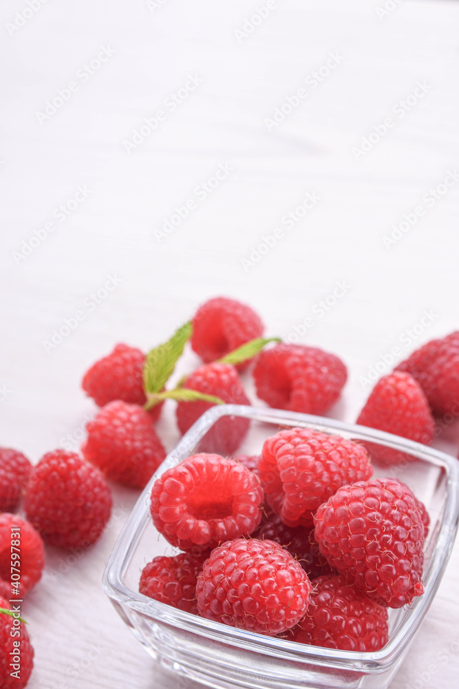 Raspberries in a bowl on a wooden textured background Raspberries in a bowl on a wooden textured background