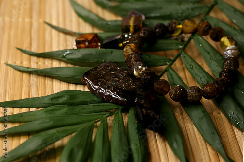 raw amber and amber in products on a natural background