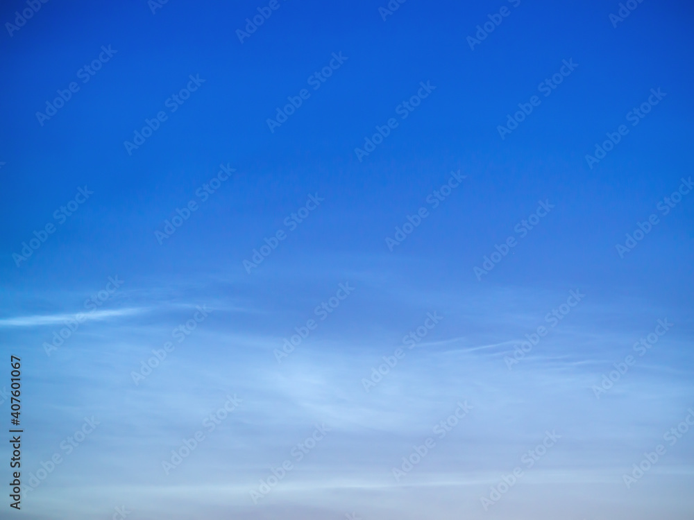 White Spindrift clouds on blue sky