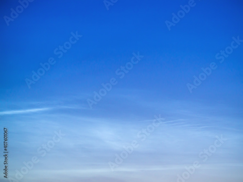 White Spindrift clouds on blue sky
