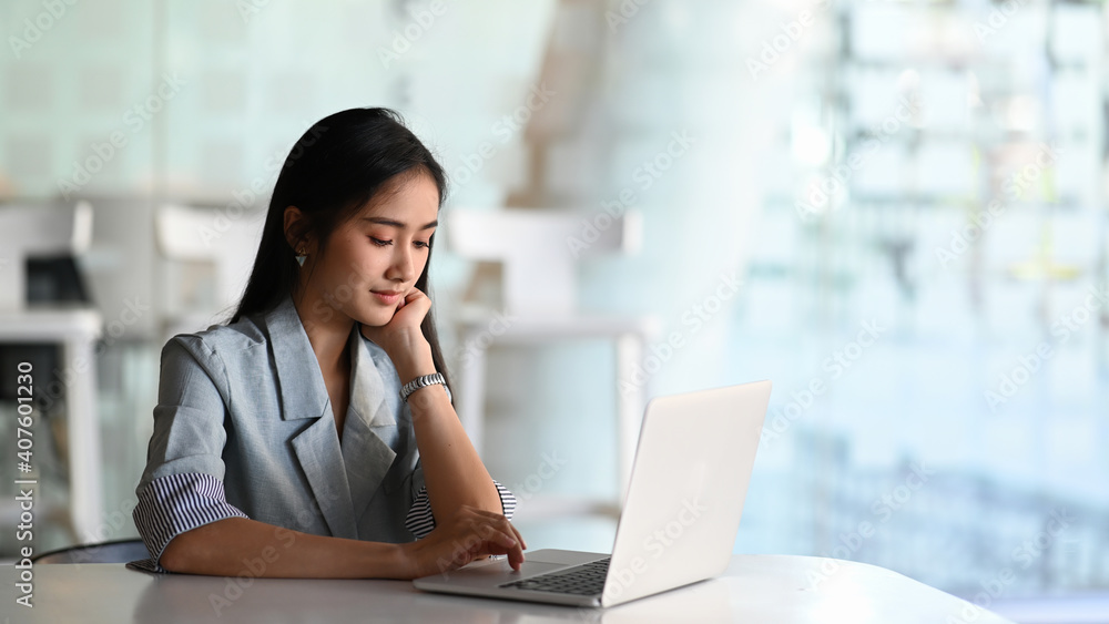 Businesswoman using laptop computer browsing internet or working at office. Businesswoman using laptop computer browsing internet or working at office.
