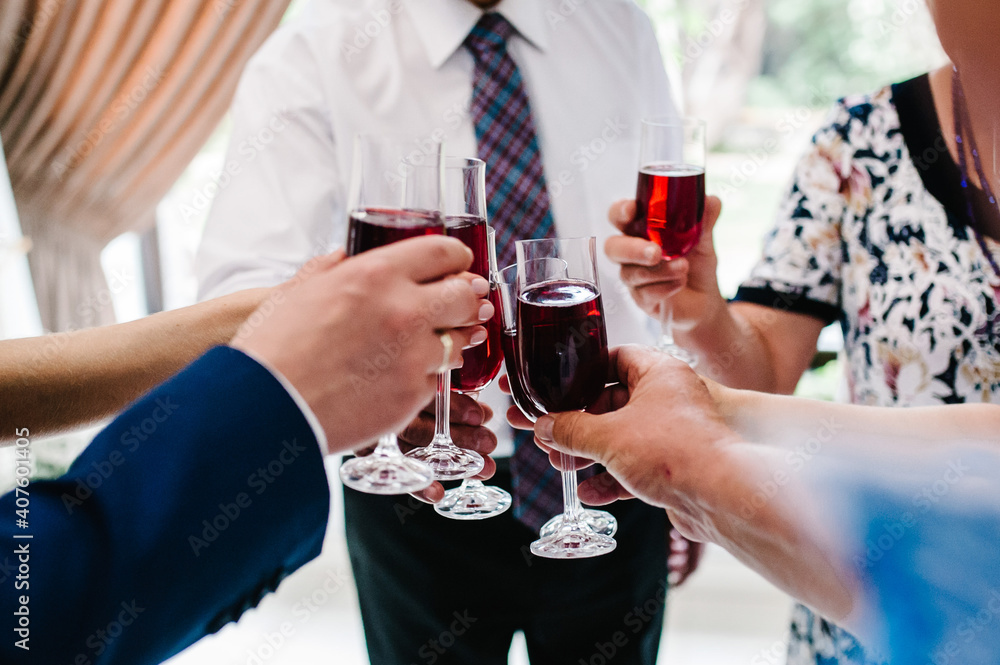 Cheers! People celebrate and raise glasses of wine for toast. Group of man and woman cheering with champagne. Cheers! People celebrate and raise glasses of wine for toast. Group of man and woman cheering with champagne.