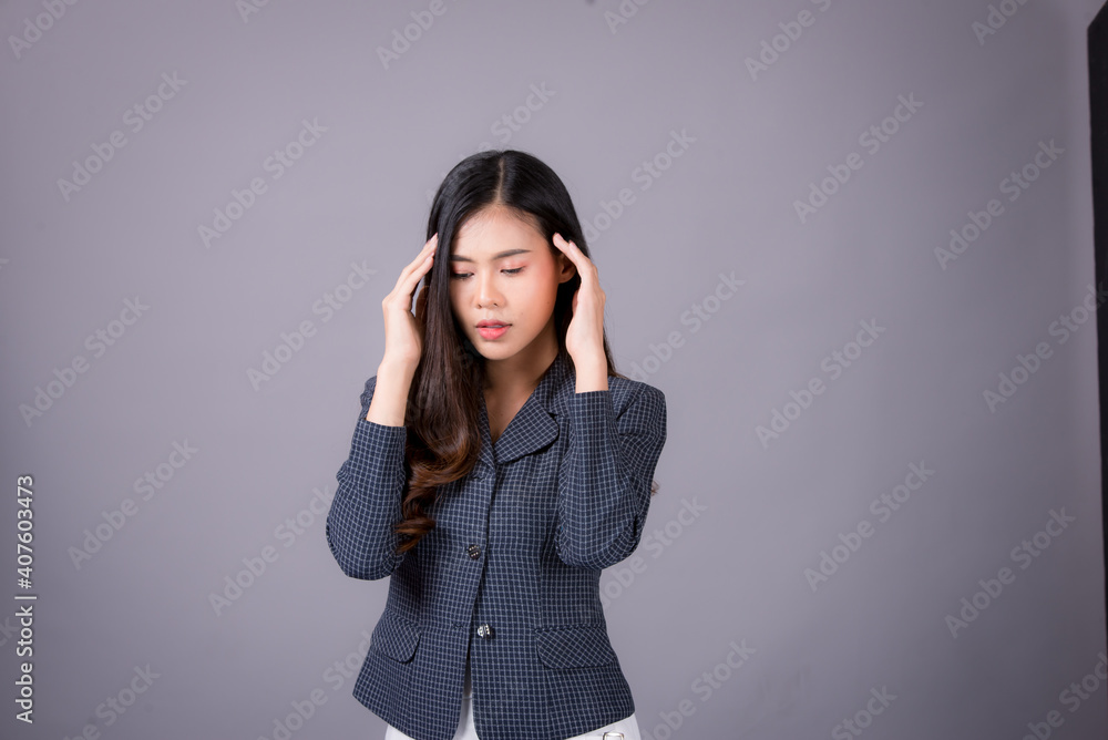 Portrait of Asian woman, happy working day.beautiful modern businesswoman ,holding tablet computer on Gray background in the studio Portrait of Asian woman, happy working day.beautiful modern businesswoman ,holding tablet computer on Gray background in the studio
