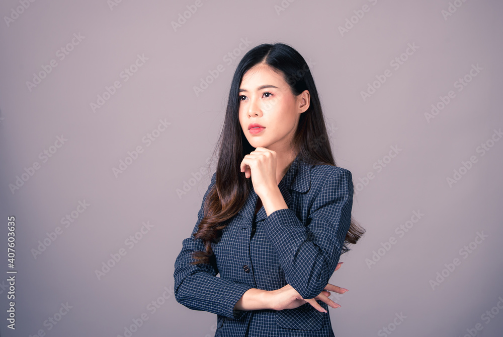 Portrait of Asian woman, happy working day.beautiful modern businesswoman ,holding tablet computer on Gray background in the studio Portrait of Asian woman, happy working day.beautiful modern businesswoman ,holding tablet computer on Gray background in the studio