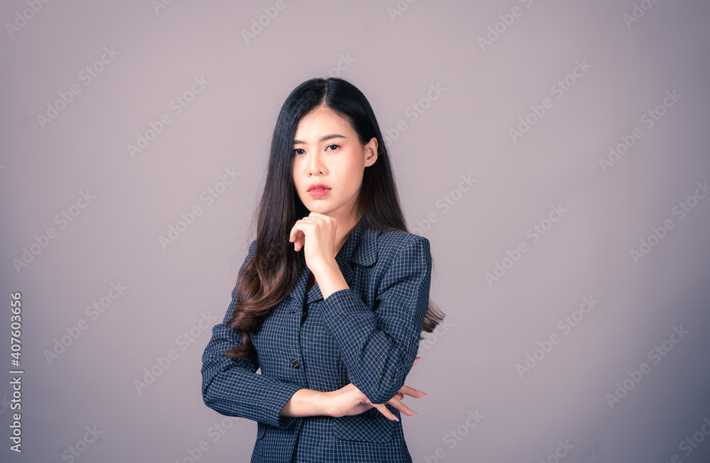 Portrait of Asian woman, happy working day.beautiful modern businesswoman ,holding tablet computer on Gray background in the studio Portrait of Asian woman, happy working day.beautiful modern businesswoman ,holding tablet computer on Gray background in the studio