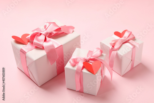 Gift boxes with with decorative hearts on pink background © Atlas