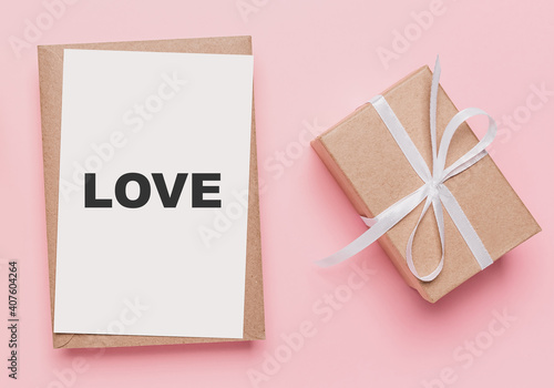 Gifts with note letter on isolated pink background, love and valentine concept with text love