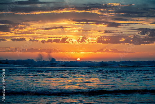 Calm seascape of Australian coastal sunset on the beach, overlooking the ocean with majestic clouds.  Mornington Peninsula, Victoria.