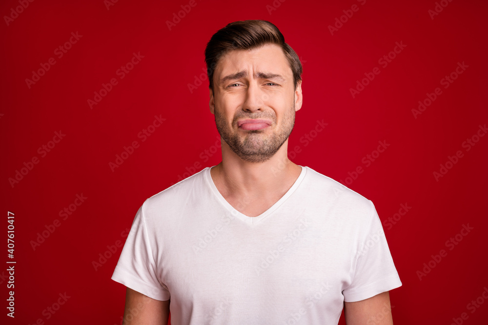 Photo portrait of sad guy crying unhappy grumpy bad mood isolated vivid red color background Photo portrait of sad guy crying unhappy grumpy bad mood isolated vivid red color background